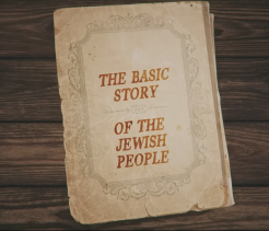 Aged book cover on a wooden surface titled “The Basic Story of the Jewish People.”
