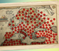 Vintage map of Europe covered with numerous red dots scattered across many countries.
