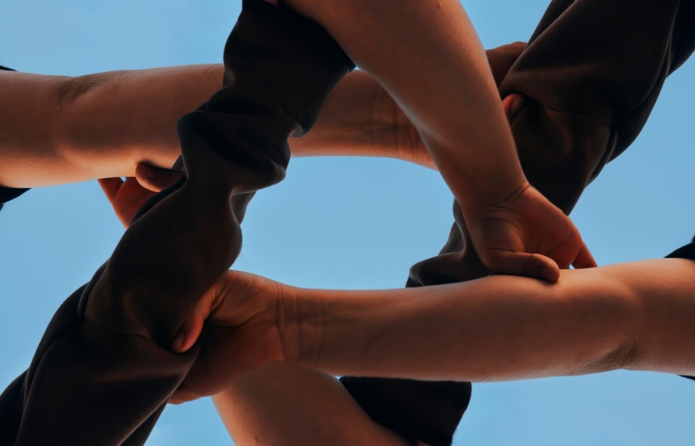 Friends put hand in hand the concept of a friend connection that make Star of David hands